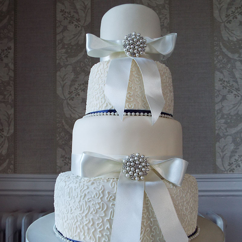 vintage wedding cake 4 tier lace ivory saffire blue ribbon brokencote hall